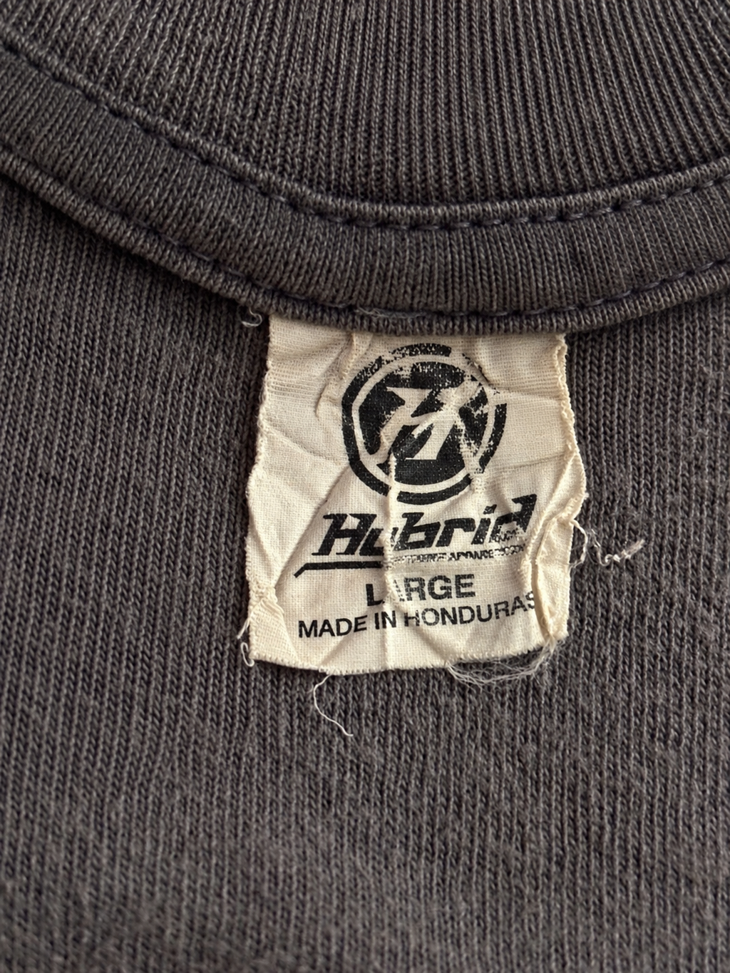 Close-up of Teenage Mutant Ninja Turtles pixel-style logo on dark graphic T-shirt