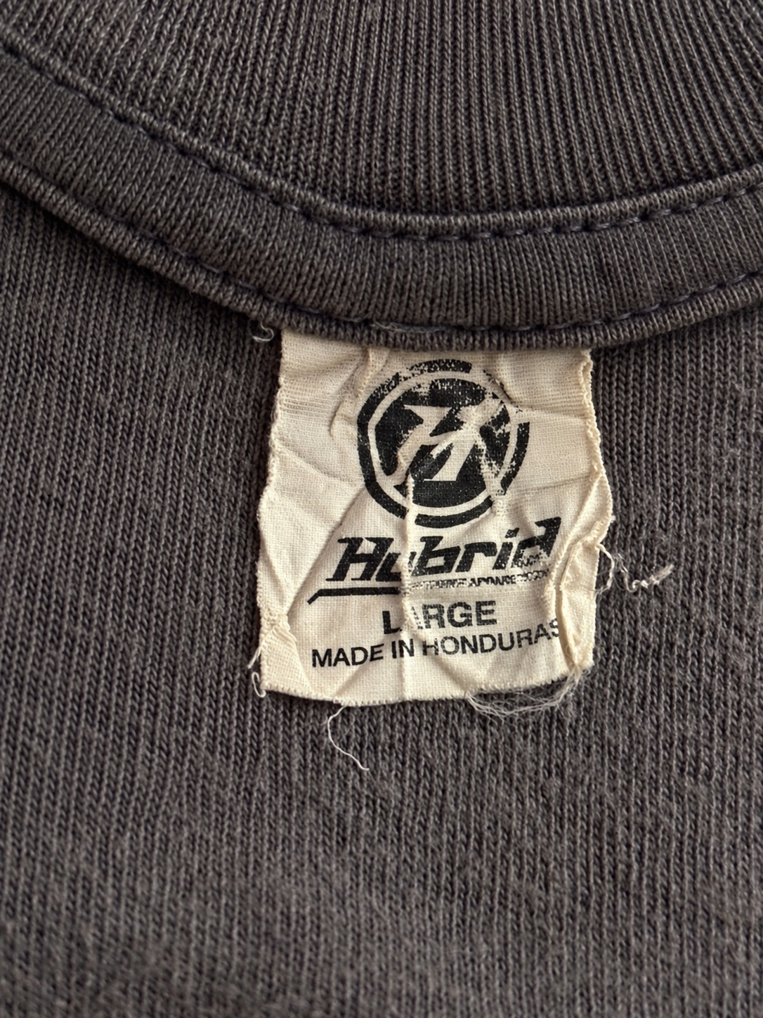 Close-up of Teenage Mutant Ninja Turtles pixel-style logo on dark graphic T-shirt