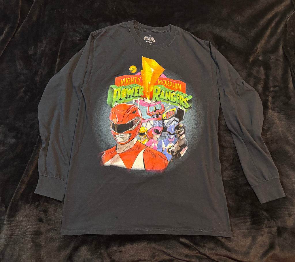 Close-up of the Mighty Morphin Power Rangers graphic on a black long-sleeve shirt