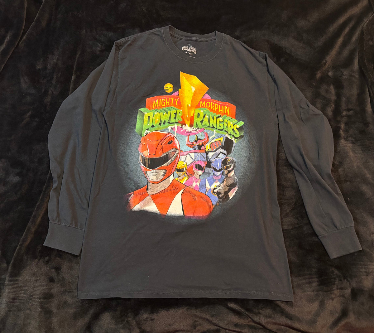 Close-up of the Mighty Morphin Power Rangers graphic on a black long-sleeve shirt