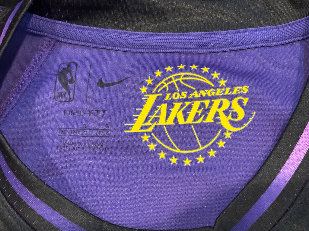 Neck tag showing Nike Dri-FIT size L 162-170cm 14/16 youth sizing, made in Vietnam