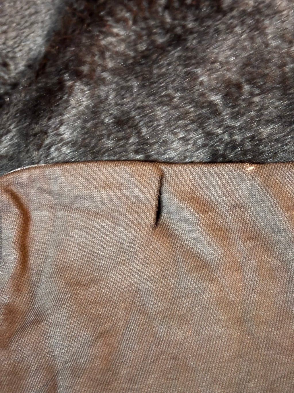 Small snip near the bottom hem (disclosed flaw)
